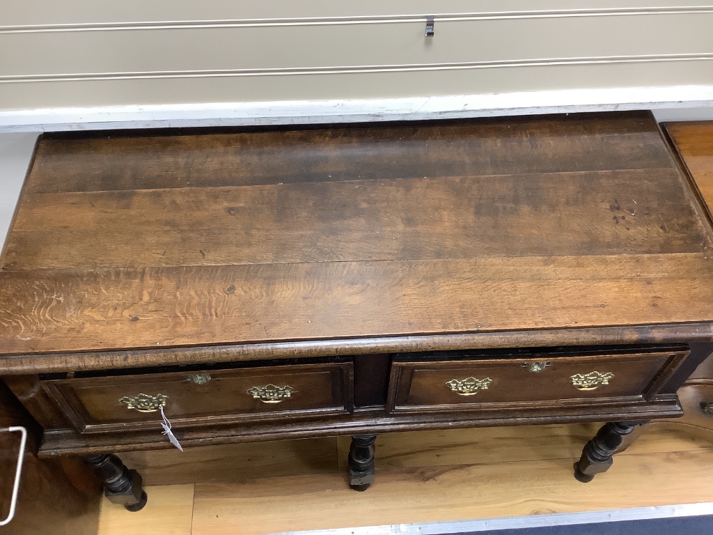 A small 18th century oak two drawer low dresser, width 124cm depth 56cm height 79cm